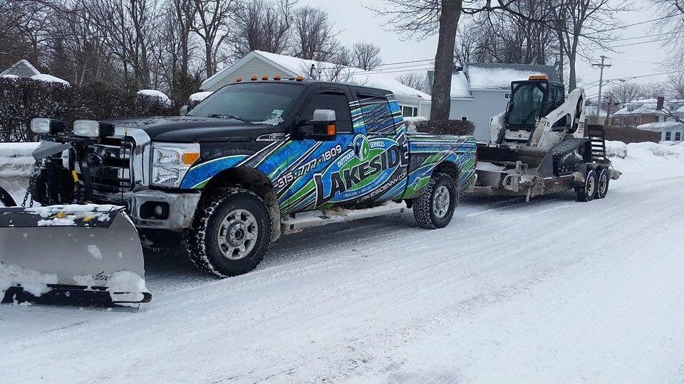 Lakeside truck and Bobcat skid steer hauling out snow after a Northern NY storm